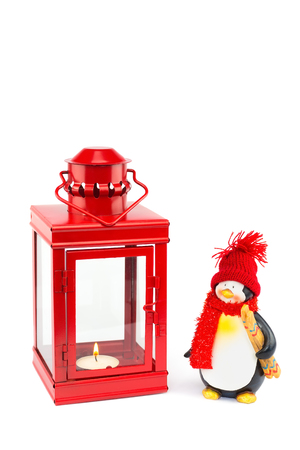 Red lantern with penguin figurine for christmas on white backgroundの写真素材
