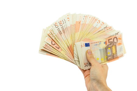 Hand holding pile of fifty euro bills isolated on white backgroundの写真素材