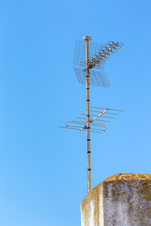 TV and Radio antenna at chimney in blue skyの写真素材