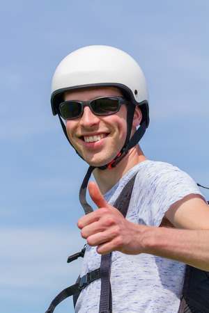 Young man as paraglider wearing sunglasses and helmetの写真素材