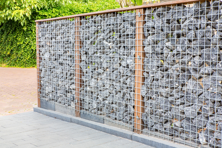 Natural garden separation with metal, wood and bouldersの写真素材