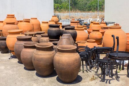 Many large orange clay vases outdoors at pottery shop in Portugalの写真素材