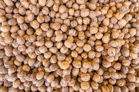 Heap of many harvested walnuts on greece marketの写真素材