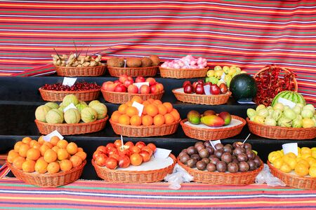 Market stall with several colorful fresh fruits on Madeira in Portugalの写真素材