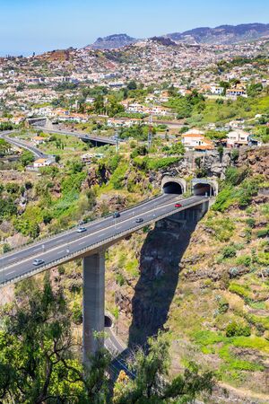 Cars driving on highway and overpass with two  tunnels at Madeira in country Portugalの写真素材