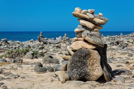 Pile of boulders on beach of bonaire with seaの写真素材