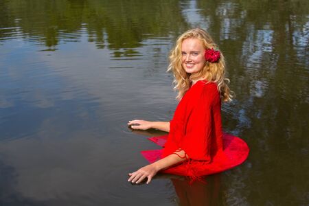 Portrait blonde dutch woman standing in natural waterの写真素材