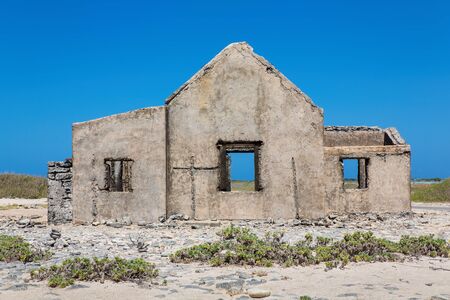 Old historic home building as ruin at coast of island Bonaireの写真素材