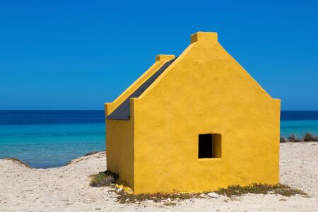 One yellow slave house at the beach of Bonaireの写真素材