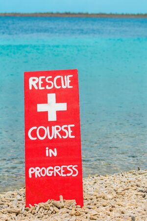 Red warning sign for rescue exercise on beach by the seaの写真素材