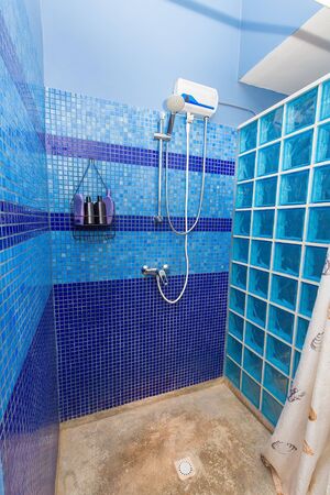 Shower cabin with blue wall tiles in apartment on Bonaireの写真素材
