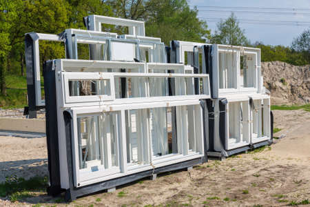 Group of white wooden window frames as delivery are outsideの写真素材