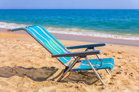 One blue beach chair at coast of Albufeira with seaの写真素材