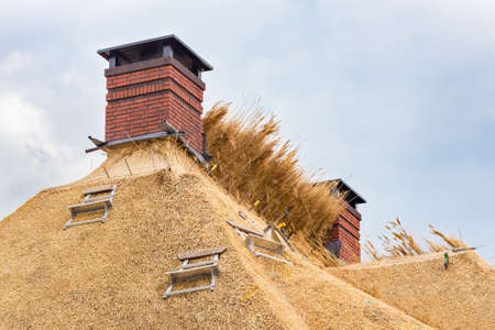 New thatched roof with two chimneys on dutch homeの写真素材