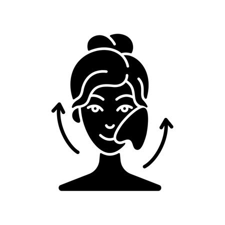 Gua sha stone black glyph icon. Removing puffiness under eyes. Angled stone. Scraping skin on face. Promoting blood flow. Chinese tool. Silhouette symbol on white space. Vector isolated illustrationのイラスト素材