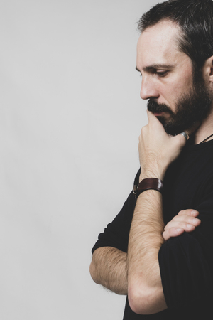 bearded thoughtful man on gray backgroundの写真素材