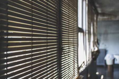 Old blinds in old and ruined abandoned house.の写真素材