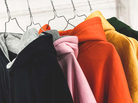 Multi colored sweatshirts on the coat rackの写真素材