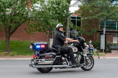 Bethesda, Md. - June 2, 2020: A Montgomery County, Md. police officer clears a road ahead of a protest and march. Protesters gathered to demand police reform following the killing of George Floyd.のeditorial素材