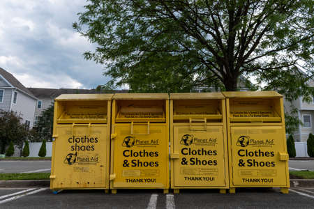 GAITHERSBURG, MD â June 26, 2020: A row of clothes donation bins sit in a parking lot in the Kentlands neighborhood in Montgomery County, Maryland.のeditorial素材