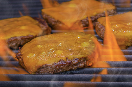 Cheeseburgers on a hot Flaming Grillの写真素材