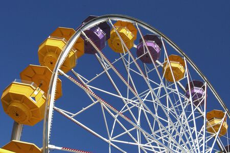 Colorful Ferris wheel on a blue skyの写真素材