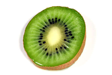 A slice of kiwi against a white background.の写真素材