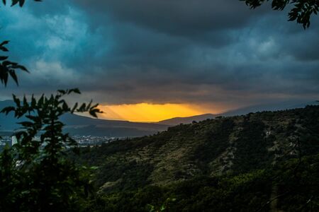 sunset in cloudy weather in the mountainsの写真素材