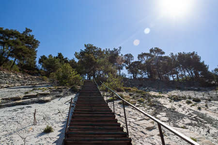 Picturesque summer landscape. A staircase on white rocks leading to the forest and camping, view from the wild beach. The outskirts of the resort city of Gelendzhik. Russia, Black sea coastの写真素材
