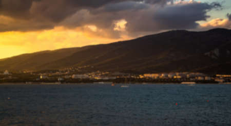 Defocused summer landscape. Sunset in cloudy weather. View of the mountains and the sea of the resort city of Gelendzhik. Russia, Black Sea coastの写真素材