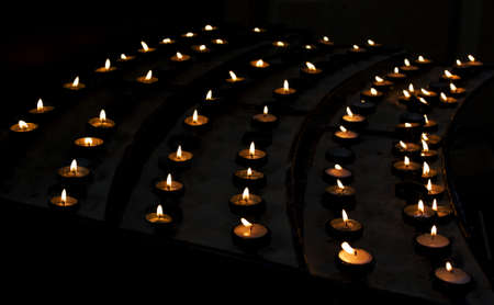 Lighted candles in church.の写真素材