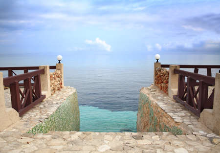 Steps leading into the Caribbean Sea, merging with the sky, at dusk.の写真素材