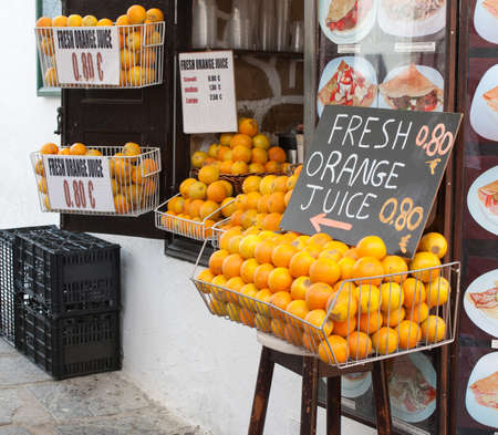 A shop in Greece selling fresh orange juice.のeditorial素材