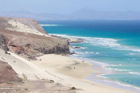 Mal Nombre beach or Playa del Mal Nombre on a windy day, with its golden sand, situated on the south east coast of the island of Fuerteventura, Canary Islands, Spain.の写真素材