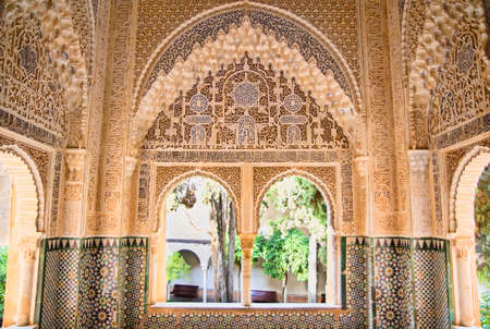 Moorish architecture in one room of the Nasrid Palaces of the Alhambra of Granada in Spain, with...