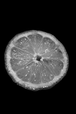 close-Up Of Halved Lemon Over Black Background , Black and whiteの写真素材