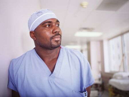 Male doctor in full scrubsの写真素材