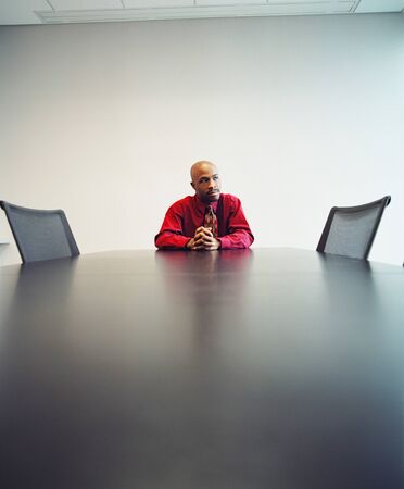 Young businessman sitting at a tableの写真素材