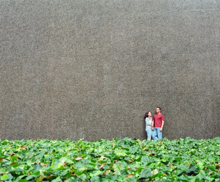 Young couple standing together against a wallの写真素材