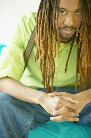 Portrait of a mid adult man sitting on a couchの写真素材