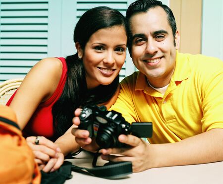 Portrait of young couple looking at camera smilingの写真素材