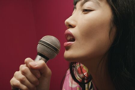 Close-up of a young woman singingの写真素材