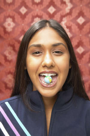 Teenage girl looking at camera smilingの写真素材