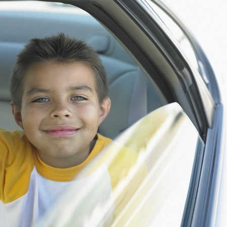 Portrait of a boy sitting in a carの写真素材