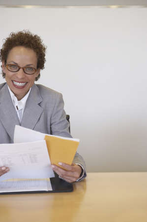 Portrait of a businesswoman holding documents and smilingの写真素材