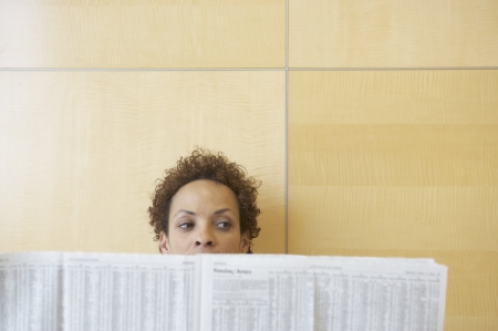 Businesswoman holding a newspaperの写真素材