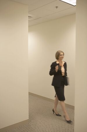 Businesswoman walking in a corridorの写真素材