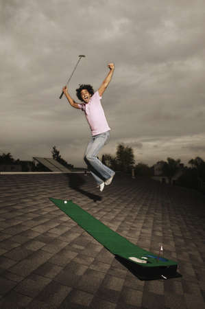 Portrait of a young man jumpingの写真素材