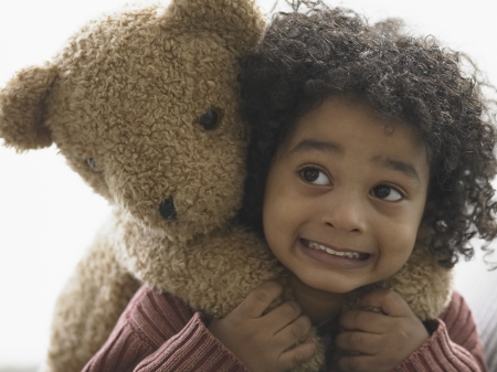 Close-up of a boy carrying teddy bear on his backの写真素材