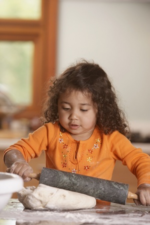 Girl rolling doughの写真素材